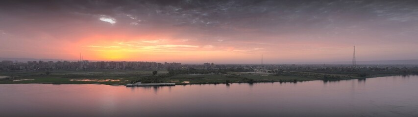 Panorama sunset scene from Sohag city in south Egypt showing Qaraman island which overlooks the Nile river
