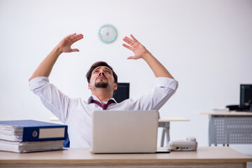 Young male employee working in the office