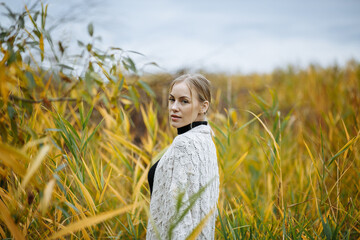 girl on a background of yellow-green pebbles