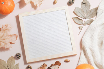 felt letter board and space for your text and leaves, pumpkins, sweater on beige background