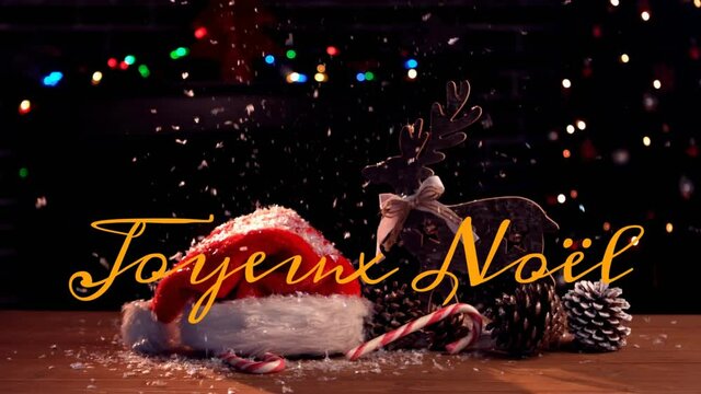Animation of joyeux noel text over christmas decorations