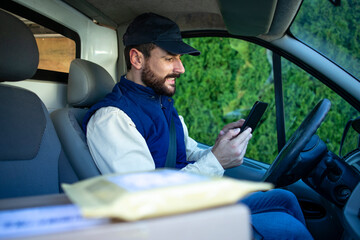 Portrait of courier in van delivering package to appropriate location.