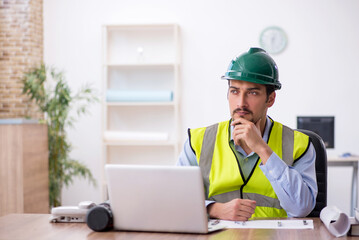 Young male architect working in the office