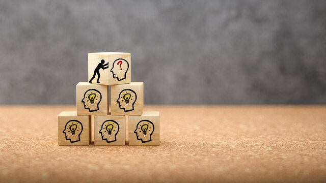 wooden cubes with idea symbols on cork background