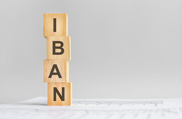 four wood cubes with the word IBAN on the background of white financial tatements, strong business...