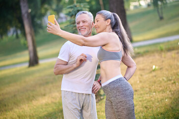 A mature happy couple making selfie and looking contented