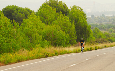 Obraz premium YOUNG TRIATHLETE RIDEING A BIKE