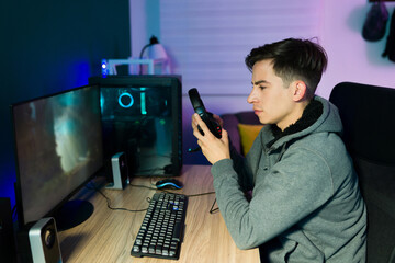 Young man putting on headphones to play videogames