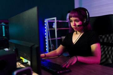 Fototapeta na wymiar Hispanic woman gaming on her pc