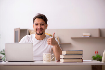 Young male student studying at home during pandemic