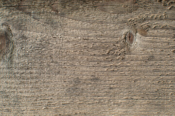 A fragment of a rough, textured, wooden board. Background image. Close-up.