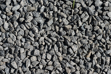 Closeup of grey gravel in the sun.