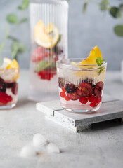 Fresh summer lemonade with berries and fruits . Raw vegan detox beverage .