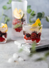 Fresh summer lemonade with berries and fruits . Raw vegan detox beverage .