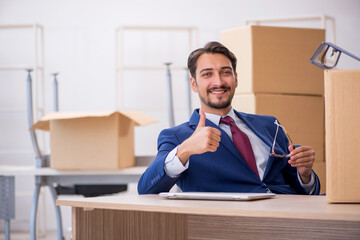 Young male employee in relocation concept