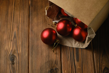 Red christmas balls in a box on a wooden table