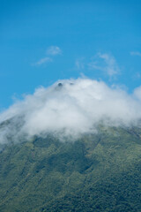 Fototapeta premium vertical as of the arenal volcano with clouds