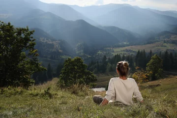 Foto op Canvas Woman enjoying beautiful mountain landscape, back view. Space for text © New Africa