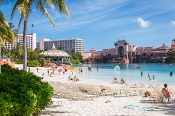 Fototapeta na wymiar One of the private beaches in Atlantis Resort, Bahamas with beautiful blue sky and palm trees 