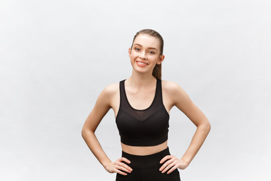 Image of a beautiful strong happy cheerful young sports woman posing isolated on grey background.
