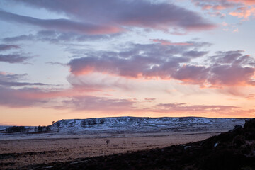 Sunrise over a snowy White Edge from Froggatt Edge, Peak District, UK