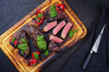 Traditional barbecue dry aged wagyu Brazilian picanha beef steaks served with chili and chimichurri...