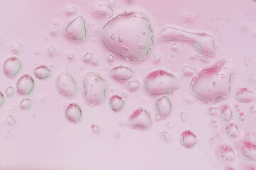 Abstract pink background with water and oil drops