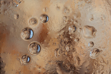 Brown background with bubbles. Oil and water with a blurry texture. Abstract photography