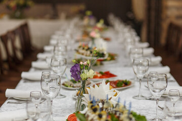 Served tables with white cloth and empty plates