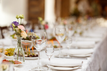Served tables with white cloth and empty plates