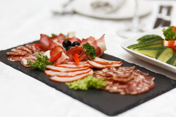 Slate plate with sliced smoked meat