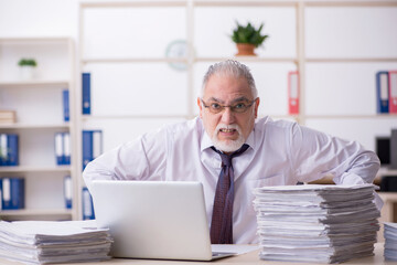 Old male employee unhappy with excessive work in the office