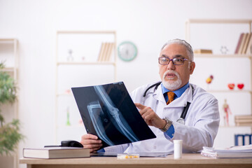 Fototapeta na wymiar Old male doctor radiologist working in the clinic