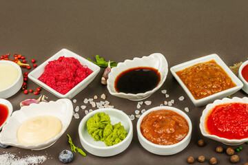 Set of different sauces - ketchup, mayonnaise, barbecue, soy, chutney, wasabi, adjika, horseradish