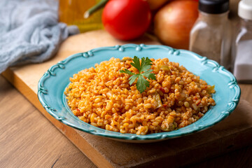 Traditional turkish bulgur pilaf with tomato sause in plate (Turkish name; meyhane pilavi)