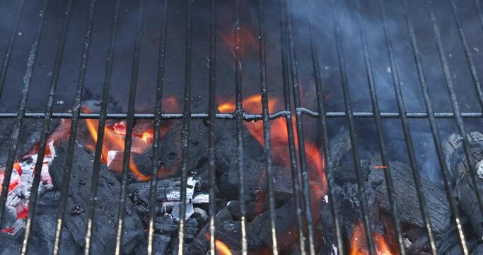 Empty barbecue grilling in summer party with flaming charcoal by open fire, a device for cook food as mea, seafood, chicken