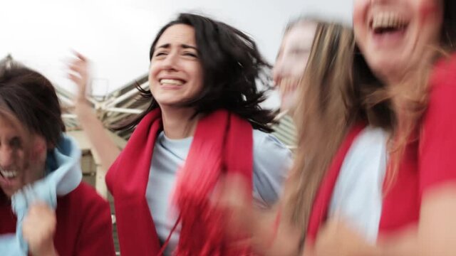 Group of young women football fans supporting and celebrating victory of their team. High quality FullHD footage