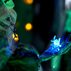 Halloween decoration garland of glowing spiders on the arm of a skeleton