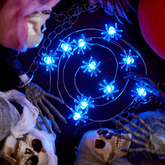 Halloween decoration garland of glowing spiders laid out in a spiral