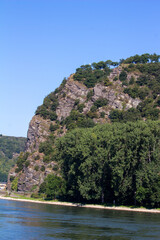 Fototapeta na wymiar Loreley Rock hillside landscape along the upper middle Rhine River, near Sankt Goarshausen, Germany. Also spelled Lorelei.