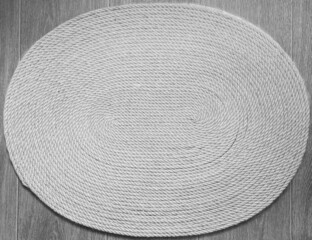 Fototapeta na wymiar handmade oval-shaped jute carpet in the interior