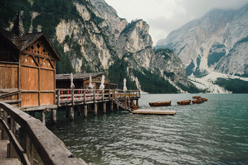 Naklejka premium Lago di Braies (Braies lake, Pragser wildsee) Lake and wooden cabin in South Tyrol, Italy ; moody evening (high ISO photography)