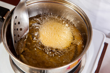 Preparation of the traditional dish from the Caribbean Coast in colombia called Arepa de Huevo or egg arepa