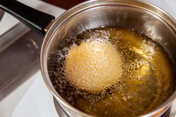 Preparation of the traditional dish from the Caribbean Coast in colombia called Arepa de Huevo or egg arepa