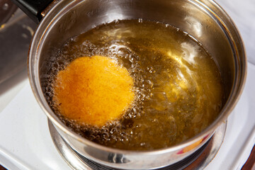 Preparation of the traditional dish from the Caribbean Coast in colombia called Arepa de Huevo or egg arepa