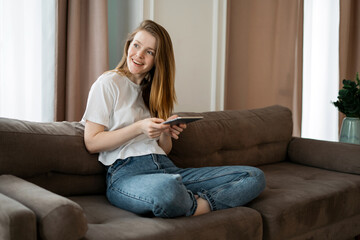 Obraz premium Student study online for free at home. A freelancer and a gadget surfs the Internet. The blogger works on the labor market company page. A woman makes a plan entry in an electronic diary.