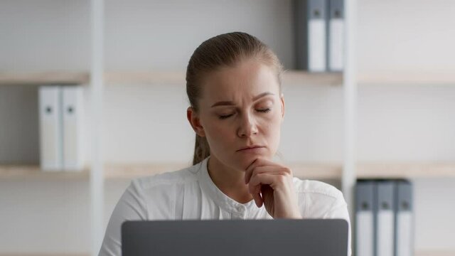 Brainstorming Concept. Pensive Young Businesswoman Working On Laptop In Office, Having Idea