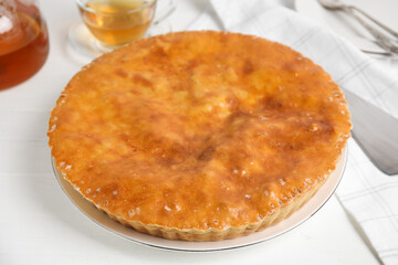 Delicious pie with meat on white wooden table
