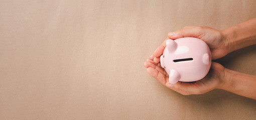Woman hand holding piggy bank, saving, charity, family finance plan concept, fundrasing community...