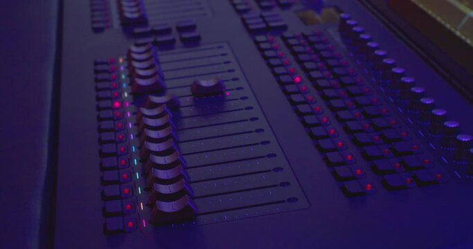 equalizers move on the remote control to adjust the sound. Audio mixer. Close-up.
